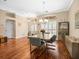 Dining room area showcasing an elegant chandelier and hardwood flooring at 5216 Kernwood Ct, Palm Harbor, FL 34685