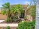 Inviting front entrance with lush landscaping and a stylish, covered entryway at 5216 Kernwood Ct, Palm Harbor, FL 34685