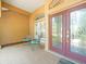 Welcoming front porch with tile flooring and comfortable seating near a decorative door at 5216 Kernwood Ct, Palm Harbor, FL 34685