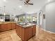 Bright kitchen with a central island and stainless appliances seamlessly connects to the dining and living areas at 5216 Kernwood Ct, Palm Harbor, FL 34685
