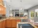 Open concept kitchen featuring an island, stainless steel appliances, and view of the living room fireplace at 5216 Kernwood Ct, Palm Harbor, FL 34685