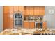 Modern kitchen features stainless steel appliances, granite countertops and warm wood cabinetry at 5216 Kernwood Ct, Palm Harbor, FL 34685