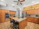 Large kitchen with granite counters, stainless appliances, a kitchen island, and ample cabinet space at 5216 Kernwood Ct, Palm Harbor, FL 34685