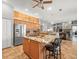 Open kitchen featuring granite countertops, wooden cabinets, an island, and stainless steel refrigerator at 5216 Kernwood Ct, Palm Harbor, FL 34685