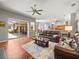 Open concept living room with access to patio and modern kitchen at 5216 Kernwood Ct, Palm Harbor, FL 34685