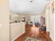 Open-concept living room with hardwood floors and elegant archway to the dining area at 5216 Kernwood Ct, Palm Harbor, FL 34685
