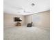 Spacious living room with neutral carpet, ceiling fan, and window with blinds, creating a comfortable atmosphere at 5216 Kernwood Ct, Palm Harbor, FL 34685