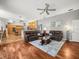Open concept living room with hardwood floors connected to modern kitchen with breakfast bar at 5216 Kernwood Ct, Palm Harbor, FL 34685