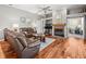 Spacious living room with hardwood floors, ceiling fan and cozy fireplace at 5216 Kernwood Ct, Palm Harbor, FL 34685