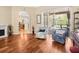 Living room showcasing hardwood floors and access to the kitchen and enclosed pool at 5216 Kernwood Ct, Palm Harbor, FL 34685