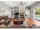 Comfortable living room with fireplace and sliding door access to the outdoor pool at 5216 Kernwood Ct, Palm Harbor, FL 34685
