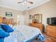 Serene main bedroom featuring natural light, plantation shutters, and hardwood floors at 5216 Kernwood Ct, Palm Harbor, FL 34685