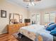 Inviting main bedroom featuring neutral tones, plantation shutters, and hardwood flooring at 5216 Kernwood Ct, Palm Harbor, FL 34685