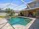 Beautiful pool and spa with brick pavers and screened enclosure, perfect for outdoor enjoyment at 5216 Kernwood Ct, Palm Harbor, FL 34685