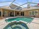 Stunning pool and spa with screened enclosure and lush landscaping in a private backyard setting at 5216 Kernwood Ct, Palm Harbor, FL 34685