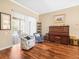 Sitting area with hardwood floors, plush armchairs, and a vintage piano at 5216 Kernwood Ct, Palm Harbor, FL 34685