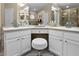 Bathroom featuring double sinks, a vanity, and white cabinets for an updated look at 5520 Terrain De Golf Dr, Lutz, FL 33558