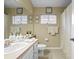 Well-lit bathroom featuring neutral walls, a tiled floor, and a white vanity at 5520 Terrain De Golf Dr, Lutz, FL 33558