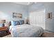 Relaxing bedroom with a queen bed, soft lighting, light blue walls, and ample closet space at 5520 Terrain De Golf Dr, Lutz, FL 33558