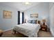 Comfortable bedroom with blue walls, side tables, bedside lamps, and a plush bed at 5520 Terrain De Golf Dr, Lutz, FL 33558