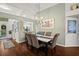 Formal dining room with elegant chandelier, stylish furnishings, and a view into the kitchen at 5520 Terrain De Golf Dr, Lutz, FL 33558