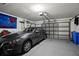 Spacious garage featuring a vehicle and ample storage space at 5520 Terrain De Golf Dr, Lutz, FL 33558