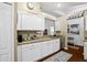 Kitchen showcasing granite counters, white cabinets and stainless steel dishwasher at 5520 Terrain De Golf Dr, Lutz, FL 33558