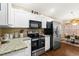 Well-lit kitchen equipped with stainless steel appliances, granite countertops, and a cozy dining area at 5520 Terrain De Golf Dr, Lutz, FL 33558