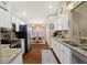 Functional kitchen with white cabinetry, granite countertops, and modern appliances at 5520 Terrain De Golf Dr, Lutz, FL 33558