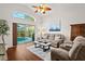 Comfortable living room with a view of the pool area, and a cozy seating arrangement at 5520 Terrain De Golf Dr, Lutz, FL 33558
