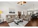 Inviting living room featuring reclining furniture, ceiling fan, and access to the dining area at 5520 Terrain De Golf Dr, Lutz, FL 33558
