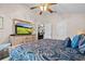 Comfortable main bedroom featuring a ceiling fan, a large dresser, and calming neutral wall tones at 5520 Terrain De Golf Dr, Lutz, FL 33558