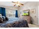 Lovely main bedroom with a ceiling fan, a large window, and a dresser with a large-screen TV at 5520 Terrain De Golf Dr, Lutz, FL 33558