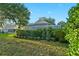 Backyard view of a screened pool area surrounded by lush landscaping at 5520 Terrain De Golf Dr, Lutz, FL 33558