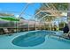 Relaxing screened-in pool area with a blue pool, lounge chairs, and a pleasant outdoor setting at 5520 Terrain De Golf Dr, Lutz, FL 33558