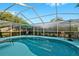 Beautiful screened-in pool with ample seating and a clear view of the sky at 5520 Terrain De Golf Dr, Lutz, FL 33558