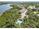 Community aerial view with pool, lake and residential buildings surrounded by lush greenery at 616 Wheaton Trent Pl, Tampa, FL 33619