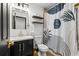 Modern bathroom featuring a black vanity, gold fixtures, and decorative shower curtain at 616 Wheaton Trent Pl, Tampa, FL 33619