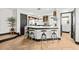 Open kitchen with sleek countertops, modern appliances, and seating at the island at 616 Wheaton Trent Pl, Tampa, FL 33619