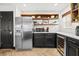Kitchen featuring stainless steel appliances, wooden shelves, and under cabinet lighting at 616 Wheaton Trent Pl, Tampa, FL 33619