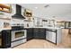 Modern kitchen featuring stainless steel appliances, quartz counters, and wooden accents at 616 Wheaton Trent Pl, Tampa, FL 33619