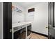 Functional laundry room featuring front-load washer and dryer with built in storage shelf at 616 Wheaton Trent Pl, Tampa, FL 33619