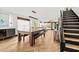 Open-concept living room featuring hardwood floors, lots of windows, and modern furnishings at 616 Wheaton Trent Pl, Tampa, FL 33619