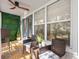 Relaxing patio with outdoor furniture, ceiling fan, privacy wall, and tiled flooring at 616 Wheaton Trent Pl, Tampa, FL 33619