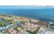 Scenic aerial perspective of yellow condo community on the water, with a marina, showcasing coastal living at 6404 Mayra Shores Ln, Apollo Beach, FL 33572