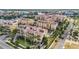 Stunning aerial view of the coastal community with well-maintained yellow condos and beautiful landscaping at 6404 Mayra Shores Ln, Apollo Beach, FL 33572