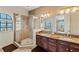 Bright bathroom featuring walk in shower, double vanity, and modern fixtures at 6404 Mayra Shores Ln, Apollo Beach, FL 33572