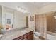 Well-maintained bathroom featuring a granite vanity, a framed mirror, and a shower with a curtain at 6404 Mayra Shores Ln, Apollo Beach, FL 33572