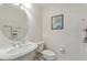 Cozy bathroom with a pedestal sink, decorative faucet, and a matching toilet at 6404 Mayra Shores Ln, Apollo Beach, FL 33572