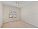Bright and airy bedroom with neutral carpet and a large window letting in natural light at 6404 Mayra Shores Ln, Apollo Beach, FL 33572